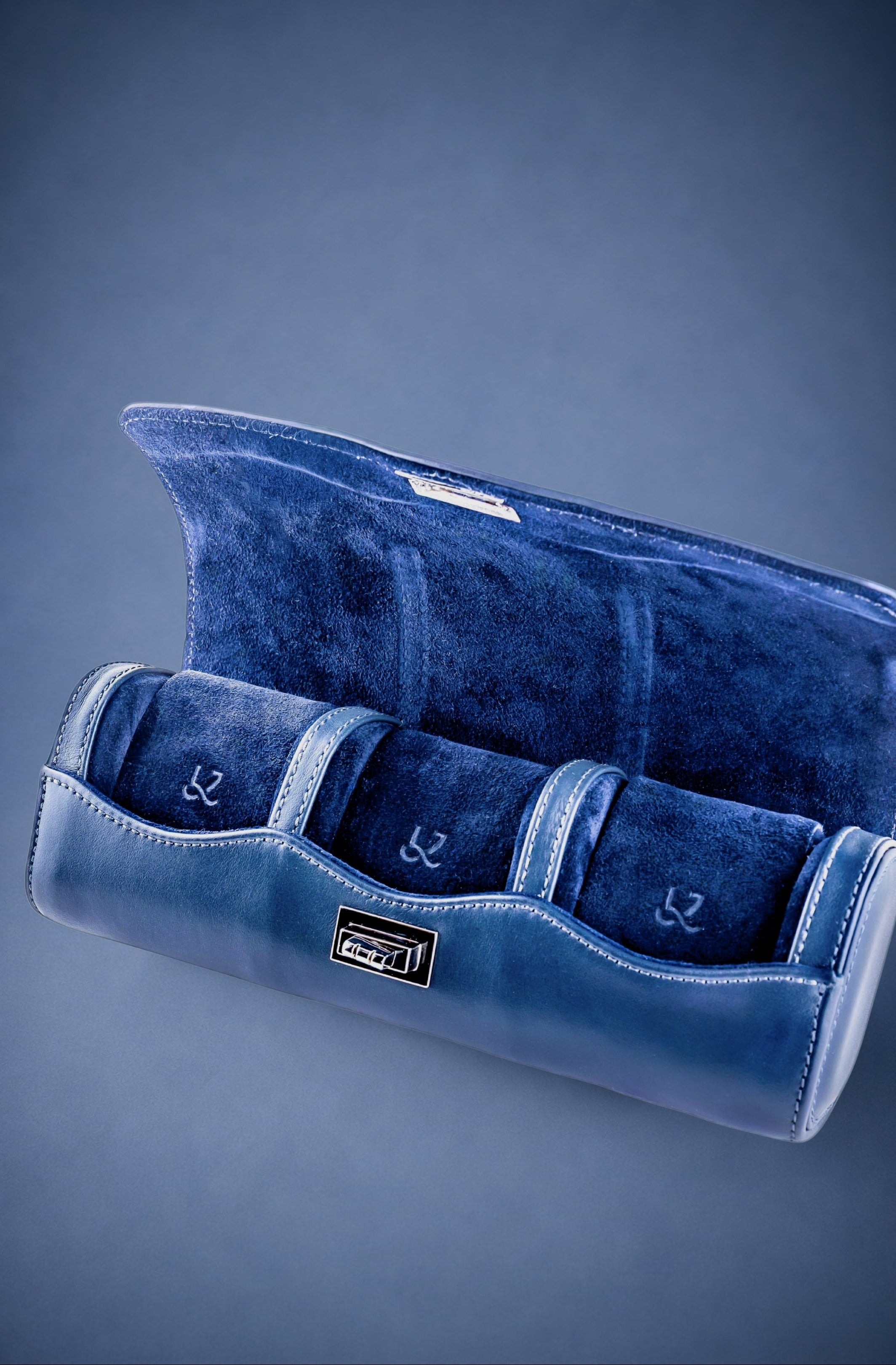 Navy Blue velvet watch roll on a blue background