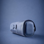 Navy Blue leather watch roll with three watches on a blue background